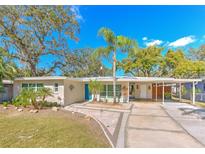 Attractive mid-century modern home with carport and landscaped yard at 8012 N Lynn Ave, Tampa, FL 33604