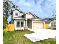 Two-story house with beige siding, gray roof, and a fenced backyard at 3033 54Th N Ave, St Petersburg, FL 33714