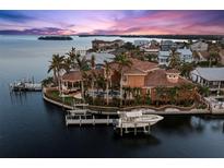 Luxury waterfront home with boat dock, pool, and stunning sunset views at 101 12Th E St, Tierra Verde, FL 33715