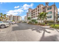 Parking lot with ample spaces and nearby building at 13313 Gasparilla Rd # 402, Placida, FL 33946