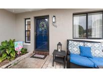 Inviting front patio with blue cushioned seating and brick pavers at 7800 Eureka Dr # 7800, Hudson, FL 34667