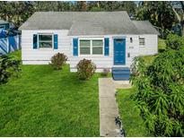 Charming bungalow with a well-manicured lawn and walkway at 215 35Th Ne Ave, St Petersburg, FL 33704