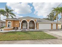 Attractive single-Gathering home with three-car garage and manicured lawn at 14202 Pullman Dr, Spring Hill, FL 34609