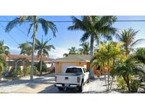 Charming single-story home with a two-car garage and lush landscaping at 16343 Redington Dr, Redington Beach, FL 33708