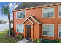 Charming townhome with a private entrance, lush landscaping, and serene lake views at 9320 Lake Chase Island Way, Tampa, FL 33626