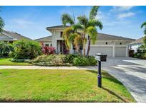 Beautiful house with landscaping, driveway, and three-car garage at 5316 Loon Nest Ct, Apollo Beach, FL 33572