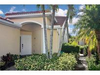 Inviting exterior with lush landscaping and a charming entrance at 311 Monaco Dr # 4, Punta Gorda, FL 33950