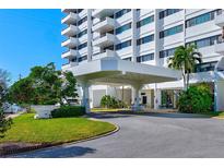 White building exterior with landscaping and covered entrance at 30 Turner St # 201, Clearwater, FL 33756