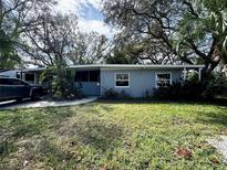 Ranch style home with gray exterior, RV parking, and large yard at 4026 Arkansas Ne Ave, St Petersburg, FL 33703