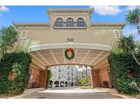 Inviting building entrance with covered parking and lush landscaping at 501 Knights Run Ave # 1217, Tampa, FL 33602