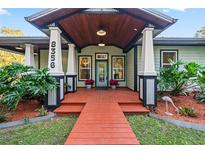 Inviting home exterior with a large front porch and walkway at 8356 Owls Roost Ln, Brooksville, FL 34601