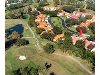 Aerial view of a community with golf course and villas at 1120 Tartan Dr, Palm Harbor, FL 34684