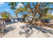 Cute light blue house with a spacious front yard and driveway at 3612 Phillips St, Tampa, FL 33619