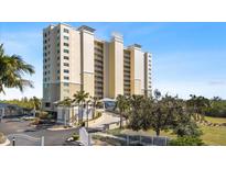 Front view of a modern high rise building with gated entrance at 10851 Mangrove Cay Ne Ln # 1112, St Petersburg, FL 33716