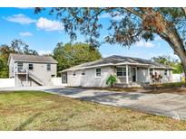 Two-story house with attached guest house and spacious driveway at 205 W 122Nd Ave, Tampa, FL 33612