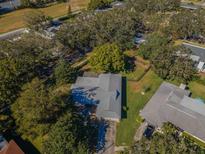 Aerial view of single-story home with large backyard and surrounding trees at 2640 Westchester N Dr, Clearwater, FL 33761