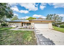 Single story home with attached garage and landscaped front yard at 2640 Westchester N Dr, Clearwater, FL 33761