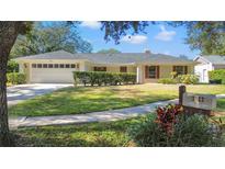 Single-story home with attached garage and manicured lawn at 3722 Village Estates Pl, Tampa, FL 33618