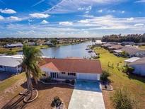 Aerial view of waterfront home with private dock and lush landscaping at 1510 Allegheny Dr, Sun City Center, FL 33573