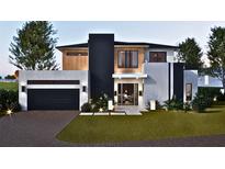 Two-story modern home with attached garage and landscaped lawn at 1810 W Erna Dr, Tampa, FL 33603