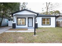 Charming home featuring a modern gray door, black and white trim, and new windows at 3508 E 24Th Ave, Tampa, FL 33605
