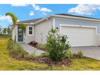 Exterior view of a single-Gathering home with a two-car garage and landscaped front yard at 6162 Timberdale Ave, Wesley Chapel, FL 33545