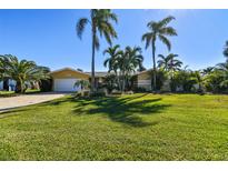 Single-story home with palm trees and spacious lawn at 936 79Th S St, St Petersburg, FL 33707