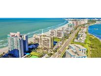 Aerial view of beachfront property with pool and tennis court at 1480 Gulf Blvd # 1107, Clearwater Beach, FL 33767