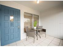 Inviting front porch featuring a blue door, neutral outdoor furniture, and bright natural light at 4444 Swift Rd # 20, Sarasota, FL 34231