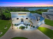 Modern waterfront home with private pool and lush landscaping at 10101 Eagle Preserve Dr, Englewood, FL 34224