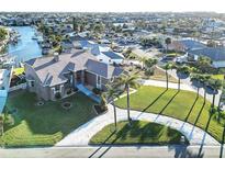 Aerial view of two-story house with landscaped yard and waterfront access at 1020 Bal Harbour Dr, Apollo Beach, FL 33572
