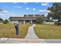 Attractive ranch-style home with landscaped lawn and walkway at 1308 Ivywood Dr, Brandon, FL 33510