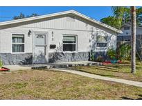 Charming single-story home with gray stone accents and well-manicured lawn at 813 89Th N Ave, St Petersburg, FL 33702