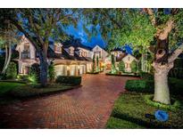 Elegant two-story home with brick driveway and landscaping at 118 Harbor View Ln, Belleair Bluffs, FL 33770