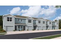 Row of modern townhomes with two stories, each featuring a private garage and light blue exterior at 4202 Red Banks Ln, Bradenton, FL 34208