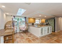 Bright kitchen with an island and tile flooring at 9830 Mark Twain Ln, Port Richey, FL 34668