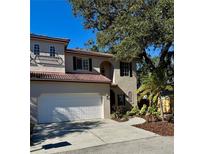 Two-story house with a large garage and mature landscaping at 6211 S Macdill Ave # 1, Tampa, FL 33611