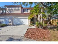 Two-story house with attached garage, landscaping, and a walkway at 6211 S Macdill Ave # 1, Tampa, FL 33611