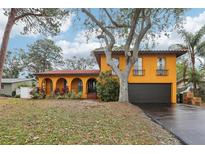 Charming two-story home with arched entry, tile roof, mature landscaping and two car garage at 14160 82Nd Ter, Seminole, FL 33776