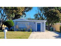 Charming single-story home with a well-manicured front yard and a striking blue front door at 13625 120Th St, Largo, FL 33778