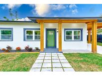 Updated home exterior with modern design and landscaping at 4008 W Leila Ave, Tampa, FL 33616