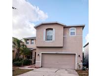 Two-story house with attached garage and neutral color scheme at 10319 Boyette Creek Blvd, Riverview, FL 33569