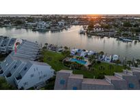 Aerial view of waterfront condo community with pool and boat slips at 370 Pinellas Bayway S # E, Tierra Verde, FL 33715