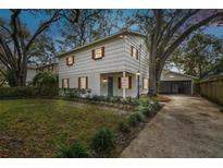 Front view of a renovated house with a driveway at 3322 W Dorchester St, Tampa, FL 33611