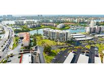 Aerial view of waterfront community with buildings, parking, and landscaping at 7400 Sun Island Dr # 501, South Pasadena, FL 33707