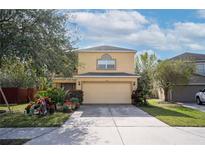 Charming two-story home with a two-car garage, driveway, and a well-maintained lawn and garden at 9703 33Rd E Ave, Palmetto, FL 34221