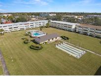 Aerial view of condo community with pool, shuffleboard, and lush landscaping at 1051 79Th N Ave # 314, St Petersburg, FL 33702