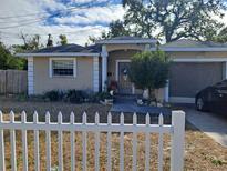 Tan house with white trim, attached garage, and picket fence at 4150 15Th S Ave, St Petersburg, FL 33711