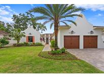 Stunning curb appeal featuring a two-car garage and lush landscaping at 16920 Villalagos De Avila, Lutz, FL 33548