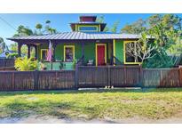 Charming green house with unique architectural details and a landscaped yard at 2515 York S St, Gulfport, FL 33707